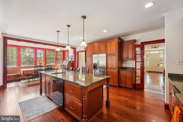 kitchen featuring stainless steel refrigerator with ice dispenser, dark wood-style floors, a sink, and black dishwasher