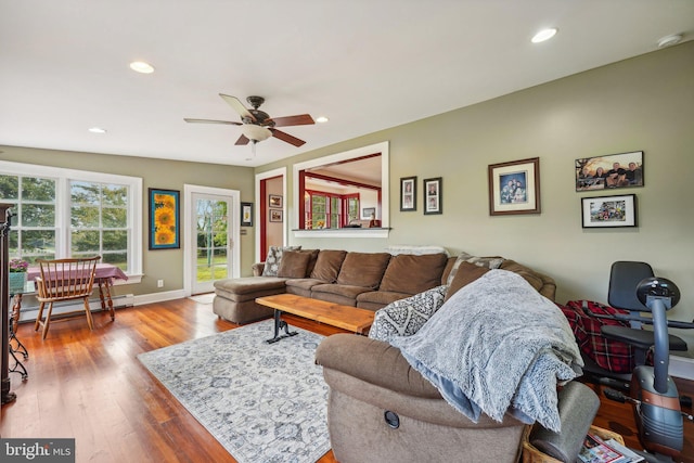living area featuring recessed lighting, baseboard heating, a ceiling fan, and wood finished floors