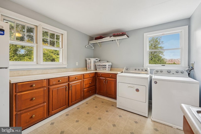 laundry area featuring washer and dryer and cabinet space