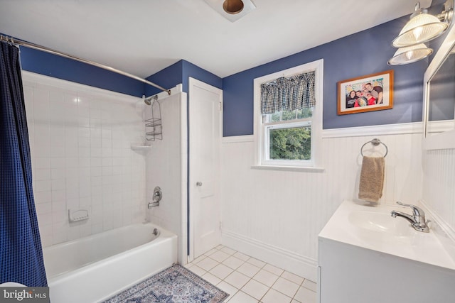 full bathroom featuring shower / bath combination with curtain, tile patterned floors, vanity, and wainscoting