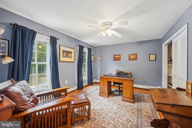 office with baseboards, a baseboard heating unit, and a ceiling fan