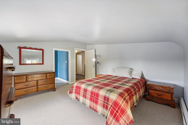 bedroom featuring carpet floors, a baseboard radiator, and lofted ceiling