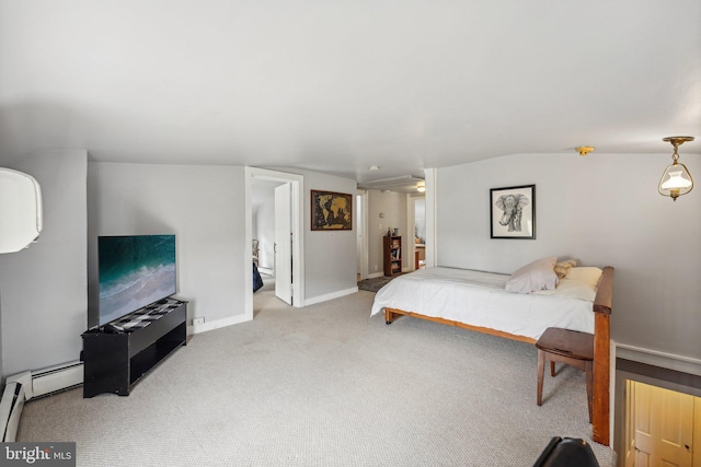 carpeted bedroom with ensuite bathroom and baseboards