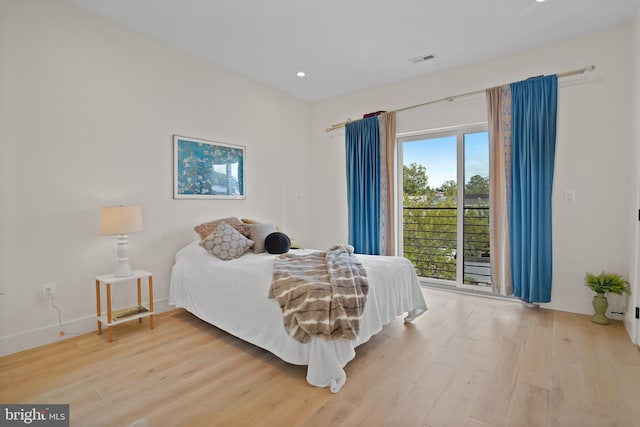 bedroom featuring light wood-type flooring and access to outside