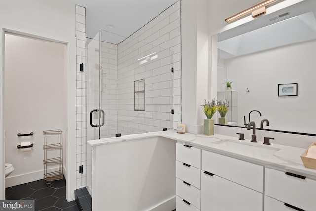 bathroom with vanity, toilet, tile patterned flooring, and a shower with door