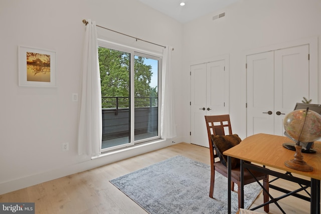 home office with light hardwood / wood-style floors