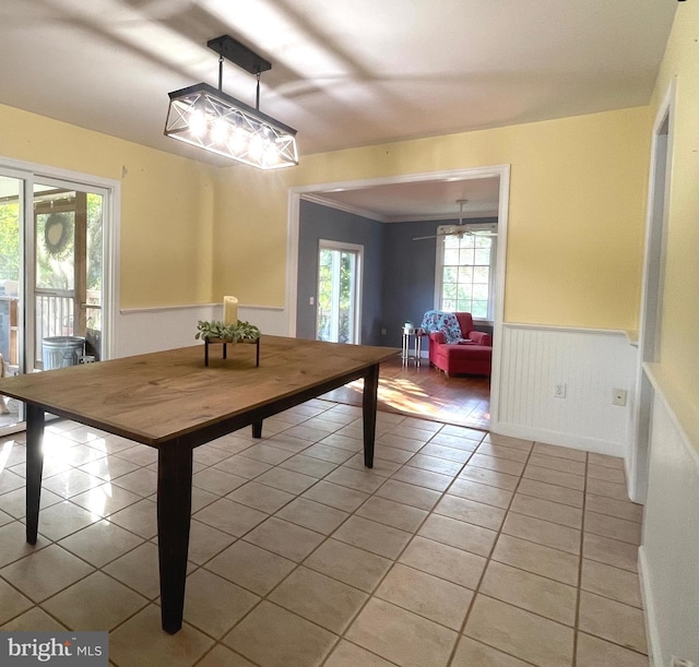 rec room with crown molding and light tile patterned floors