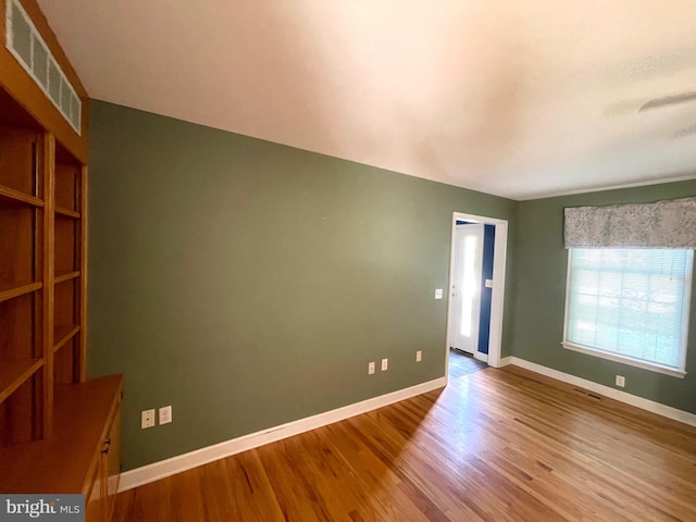 spare room with hardwood / wood-style flooring