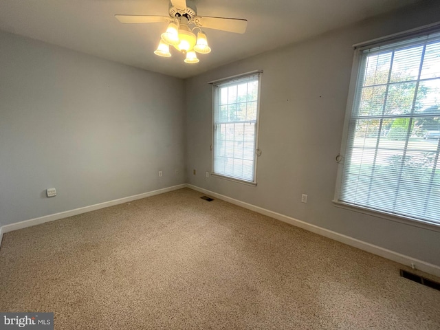 unfurnished room with ceiling fan, plenty of natural light, and carpet flooring