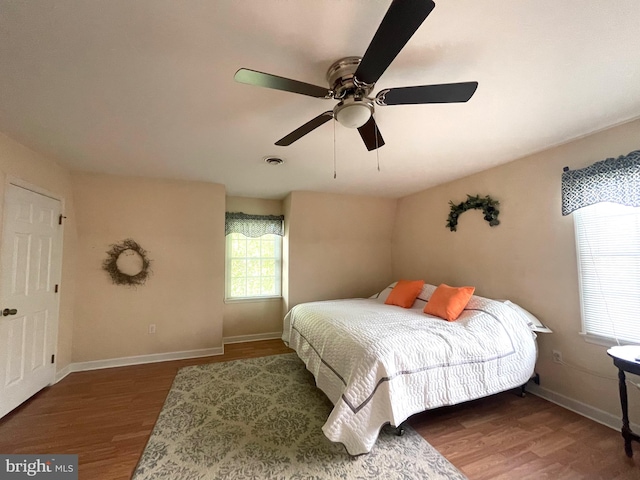 bedroom with ceiling fan and dark hardwood / wood-style floors