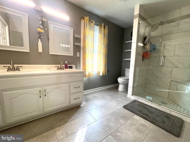 bathroom with vanity, tile patterned flooring, toilet, and an enclosed shower