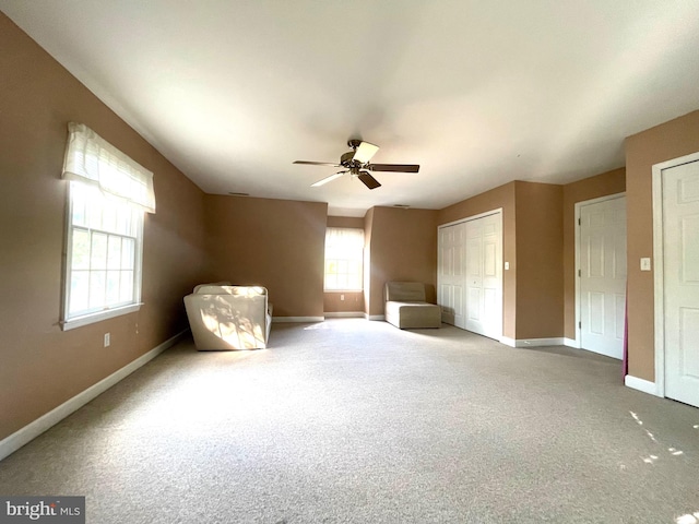 unfurnished bedroom with ceiling fan and carpet flooring