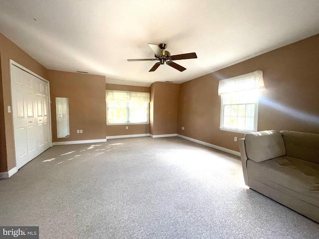 unfurnished room with carpet flooring and ceiling fan