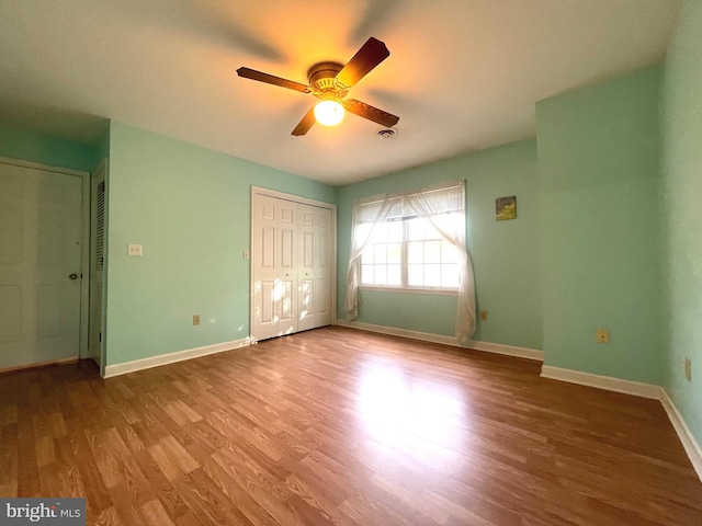 unfurnished bedroom featuring ceiling fan and hardwood / wood-style flooring