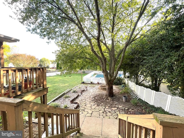 view of yard featuring a pool side deck and a patio area