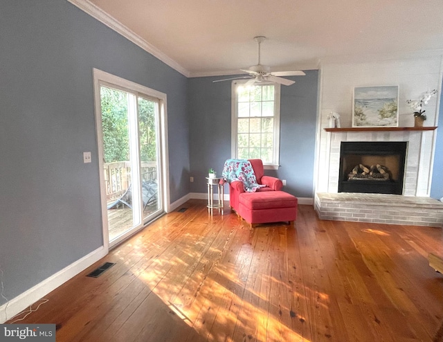 sitting room with a healthy amount of sunlight, ceiling fan, and hardwood / wood-style flooring