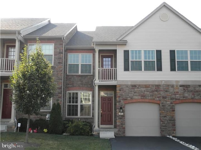 multi unit property with a balcony and a garage