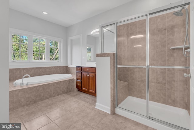 bathroom with vanity, plus walk in shower, and tile patterned floors