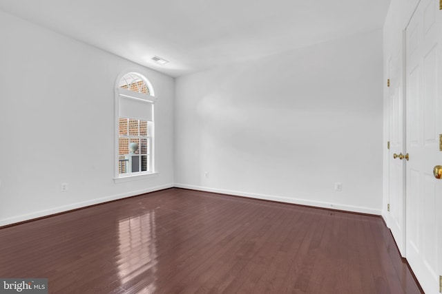 unfurnished room with dark hardwood / wood-style floors