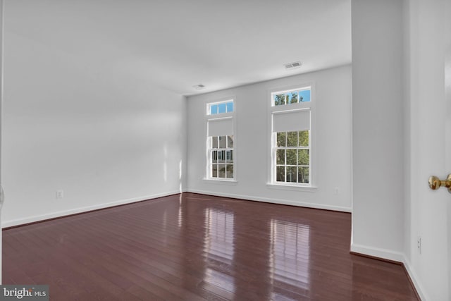 empty room featuring dark wood-type flooring