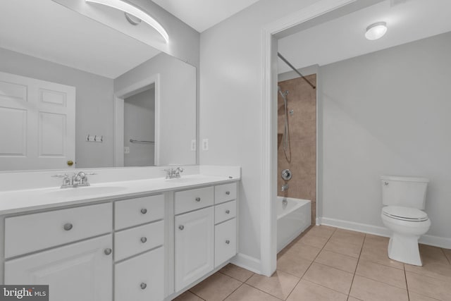 full bathroom with tiled shower / bath, vanity, toilet, and tile patterned floors