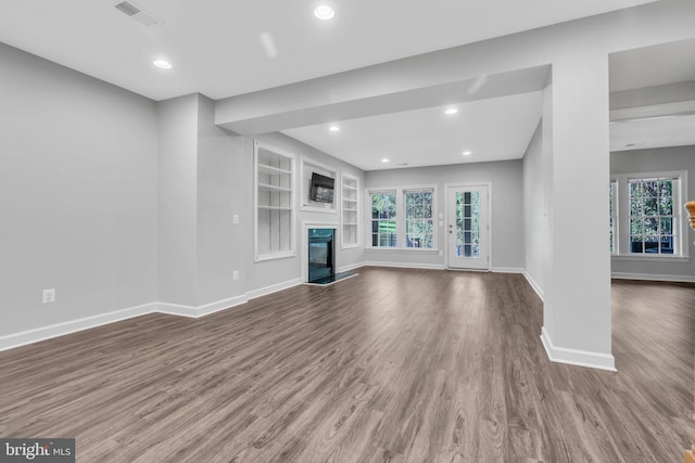 unfurnished living room featuring wood-type flooring