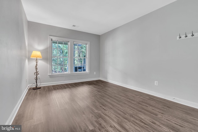 empty room featuring dark wood-type flooring