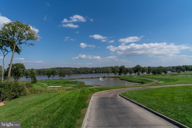 surrounding community featuring a water view and a yard