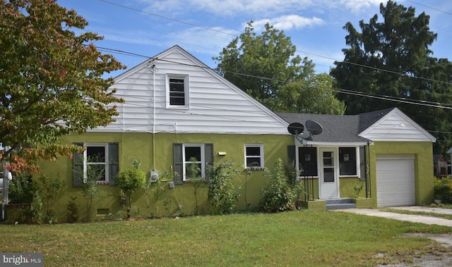 104 School Ln, Georgetown, DE 19947 - view of front of property featuring an attached garage, a shingled roof, a front yard, and stucco siding
