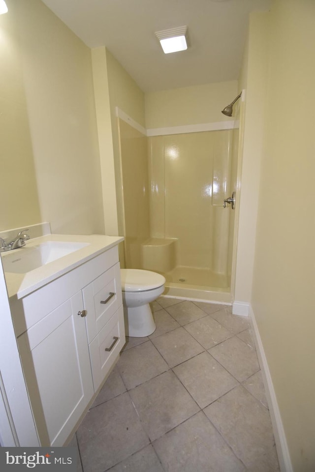 104 School Ln, Georgetown, DE 19947 - bathroom featuring vanity, tile patterned floors, a shower stall, and toilet