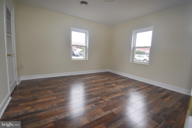 104 School Ln, Georgetown, DE 19947 - unfurnished bedroom featuring visible vents, baseboards, dark wood-type flooring, and multiple windows