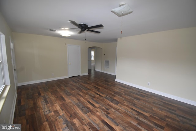 104 School Ln, Georgetown, DE 19947 - spare room with a ceiling fan, visible vents, arched walkways, baseboards, and dark wood-style floors