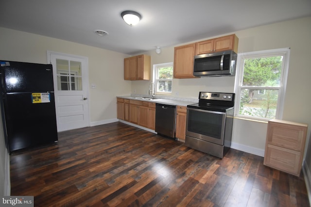 104 School Ln, Georgetown, DE 19947 - kitchen featuring dark wood-style flooring, baseboards, light countertops, a sink, and stainless steel appliances