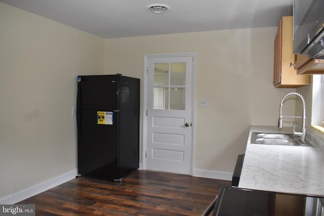104 School Ln, Georgetown, DE 19947 - kitchen featuring a sink, baseboards, freestanding refrigerator, and dark wood finished floors