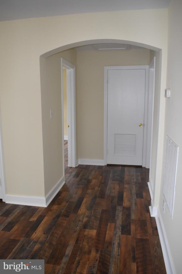 104 School Ln, Georgetown, DE 19947 - hall featuring arched walkways, baseboards, visible vents, and dark wood-style floors