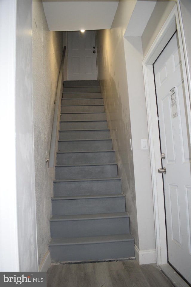 stairs with hardwood / wood-style flooring