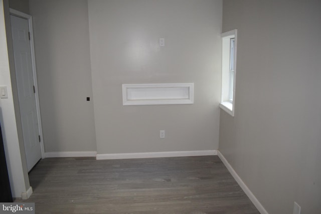 unfurnished room featuring dark wood-type flooring