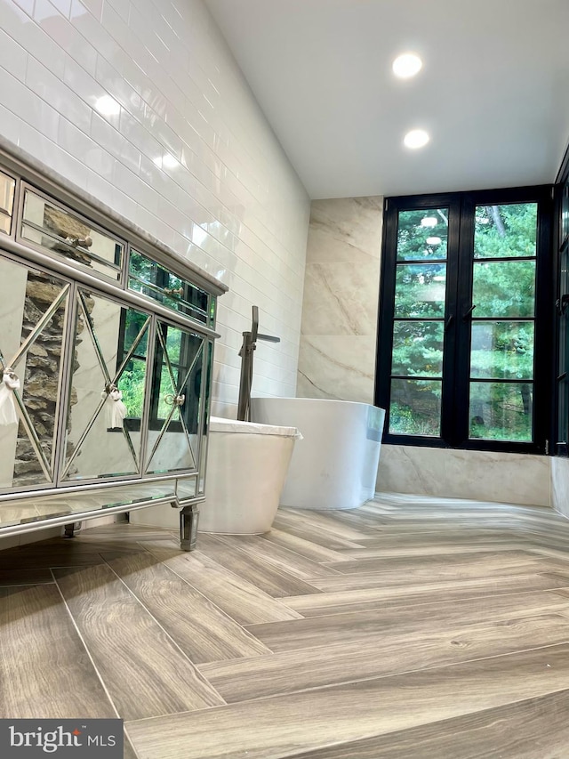 bathroom featuring a bathtub and plenty of natural light