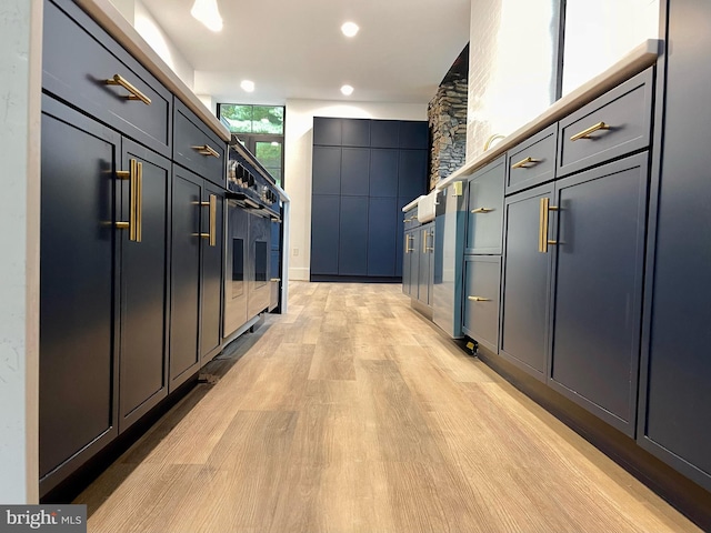 hallway featuring a package area and light hardwood / wood-style floors