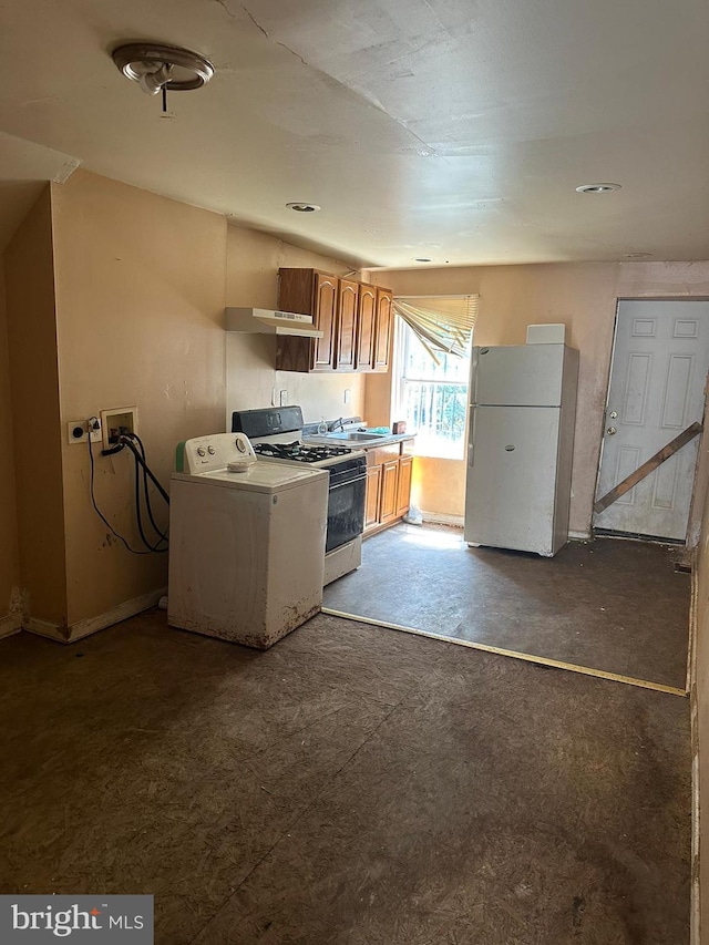 kitchen with white appliances, washer / clothes dryer, and sink