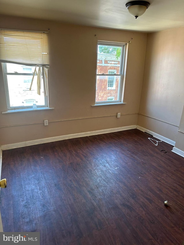 empty room featuring dark wood-type flooring