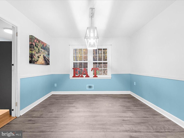 unfurnished dining area featuring hardwood / wood-style flooring