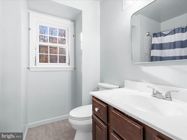 bathroom featuring toilet and vanity