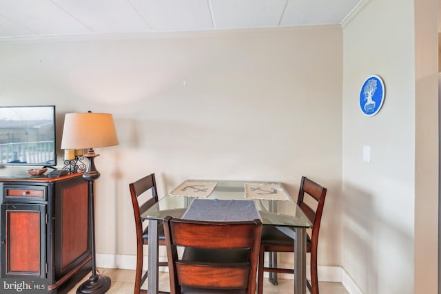 tiled dining area with crown molding