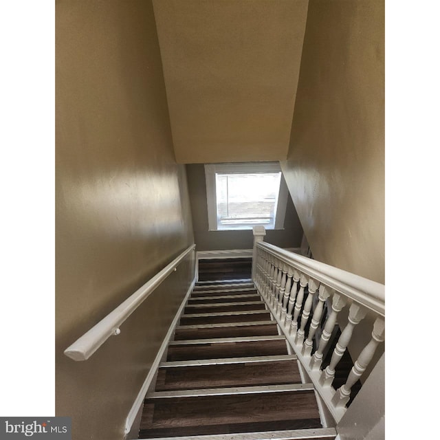 stairs featuring wood-type flooring