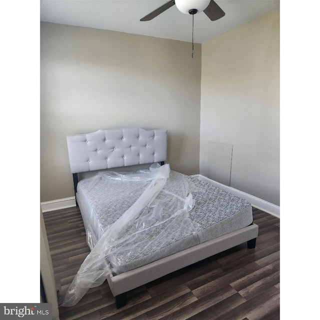 bedroom with dark hardwood / wood-style floors and ceiling fan