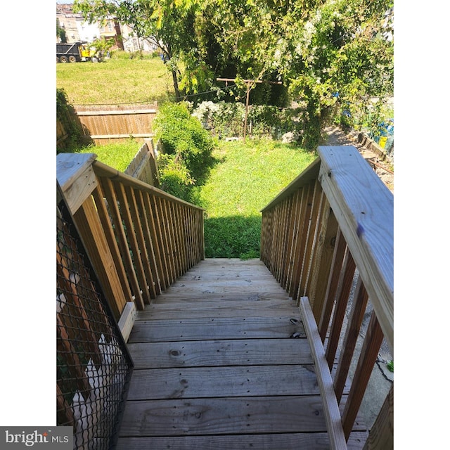 wooden terrace with a lawn