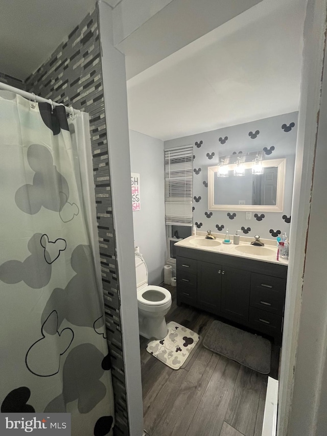 bathroom featuring hardwood / wood-style floors, vanity, toilet, and a shower with shower curtain