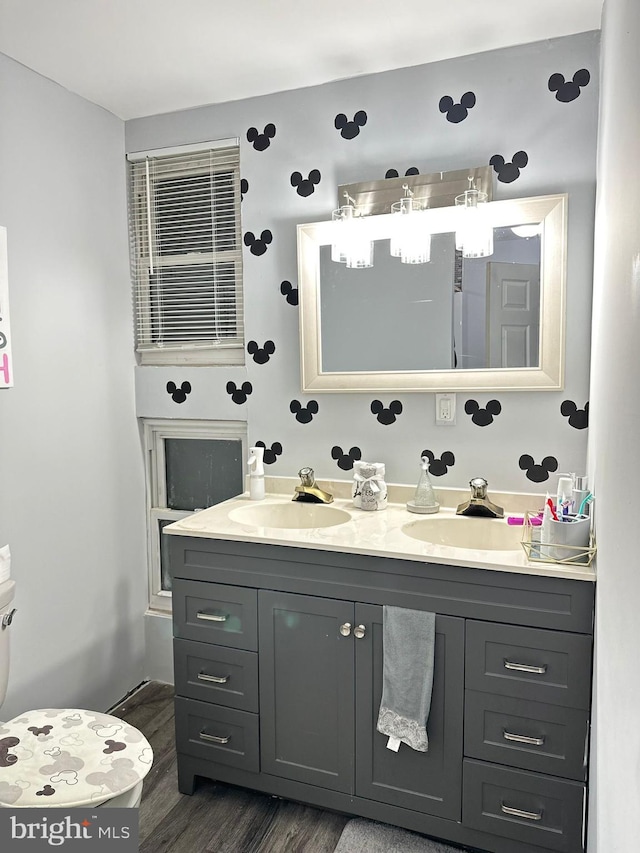 bathroom featuring wood-type flooring, vanity, and toilet