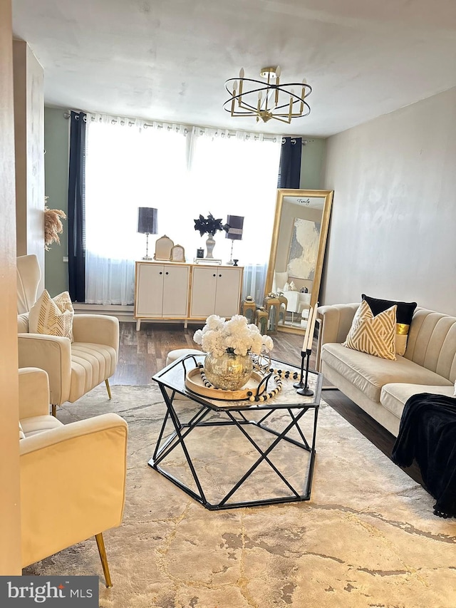 living room featuring an inviting chandelier and light hardwood / wood-style floors